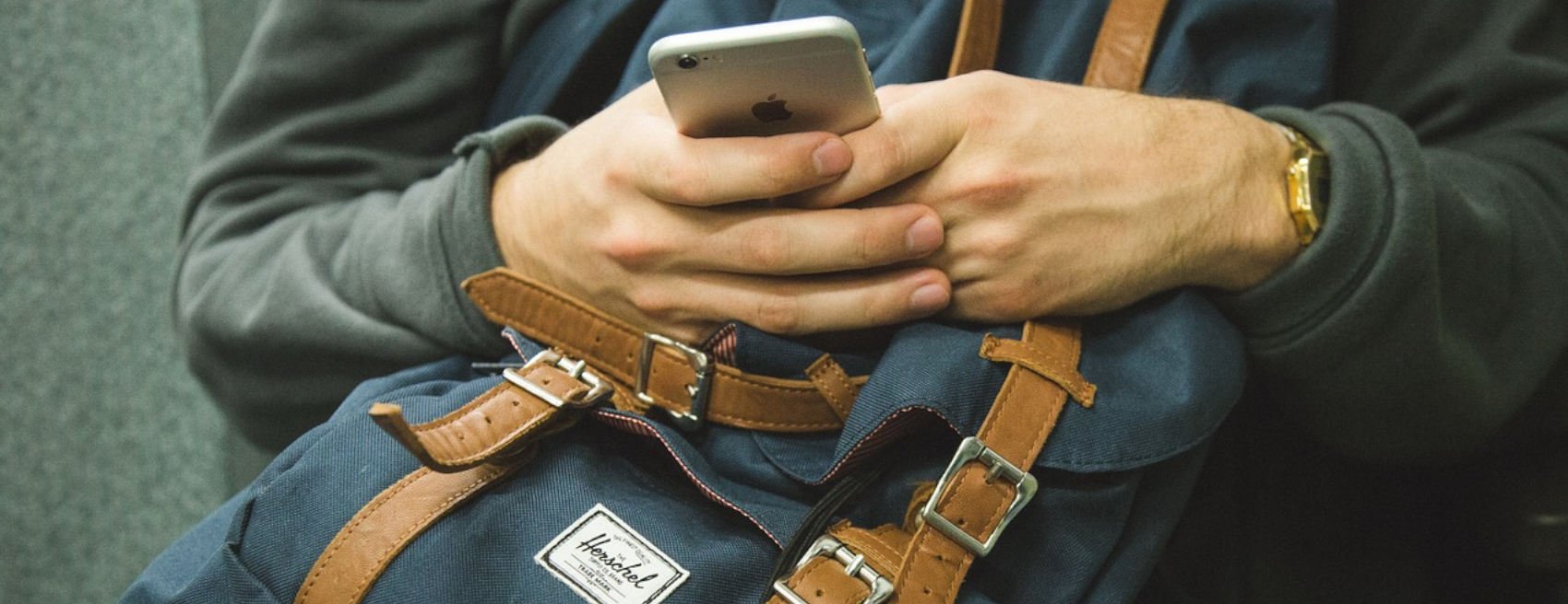 Man uses his phone while on the go